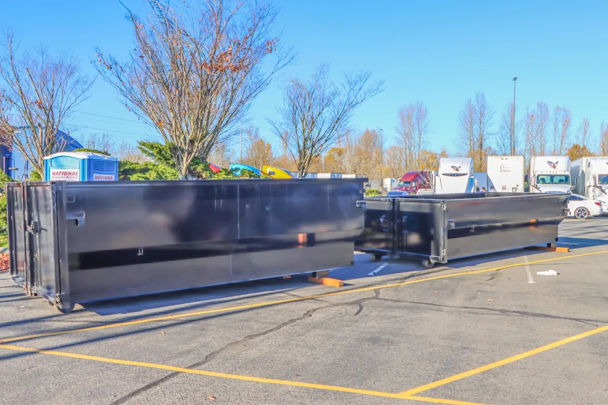 Professional dumpster rental service with roll-off container on residential driveway in East Hemet